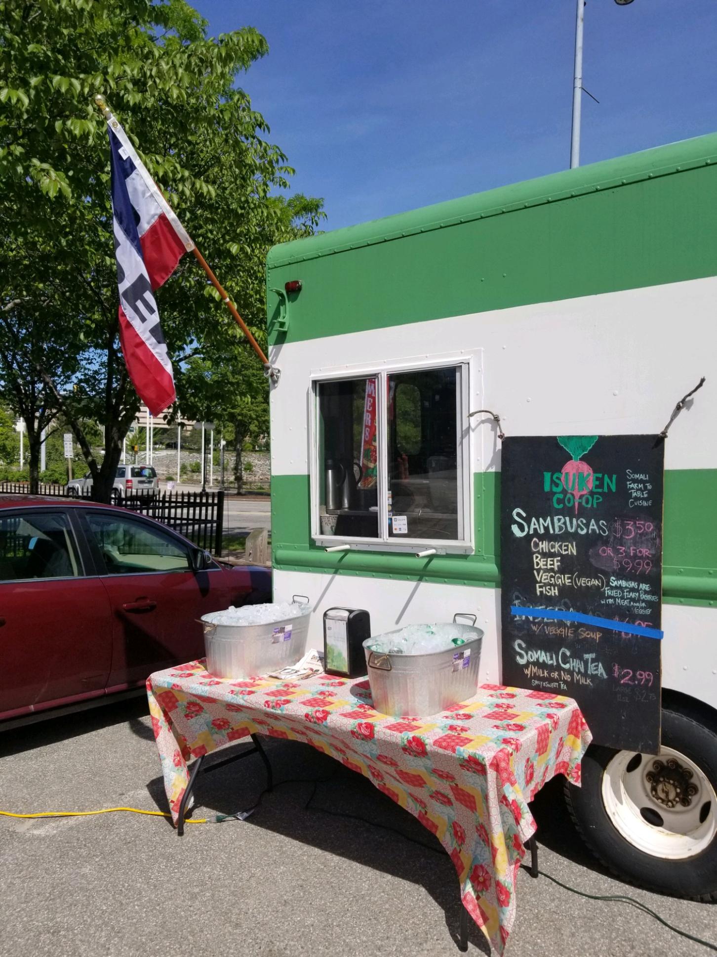 Table set in front isuken coop food truck