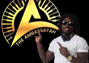 Owner standing with Ambassatah music Logo