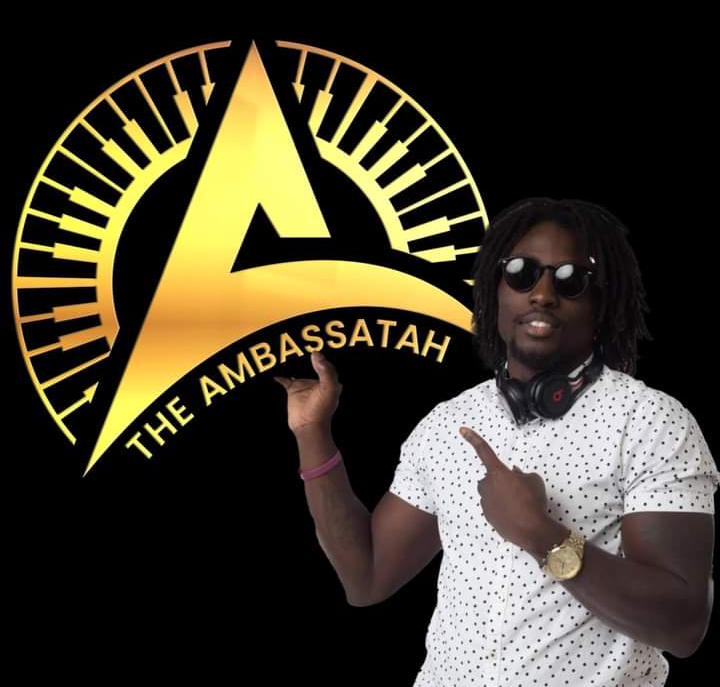 Owner standing with Ambassatah music Logo