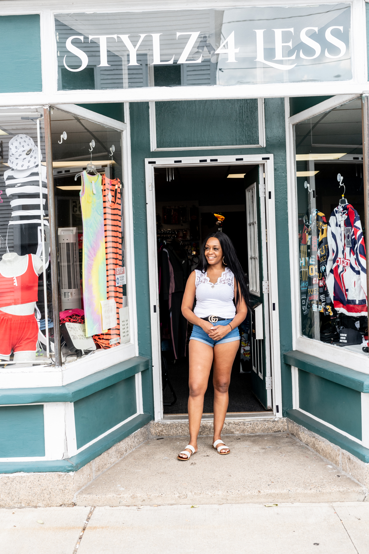 Owner of Stylz 4 Less standing outside her store front