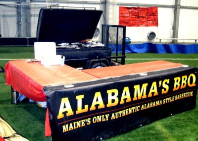 Alabama bbq catering table set up with a banner