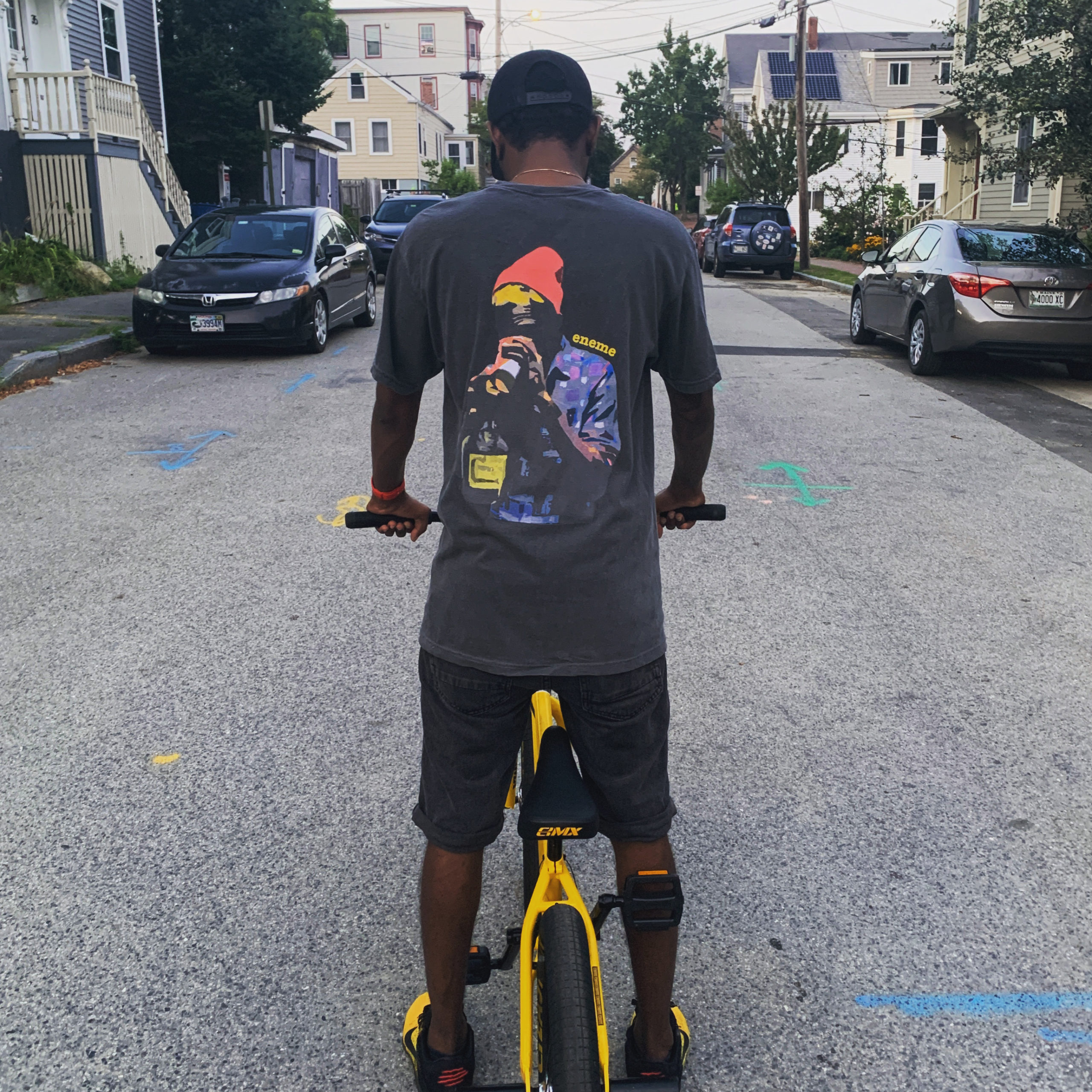 Man on bicycle wearing cloth gotten from eneme clothing co
