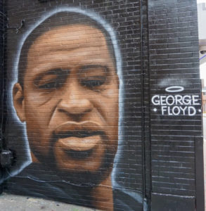 Spray painting of George Floyd on black background