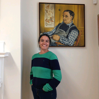 Rachel Walls stands before artist Dahlov Ipcar's portrait of her father, the renowned artist William Zorach. Photograph by Pat Davidson Reef.